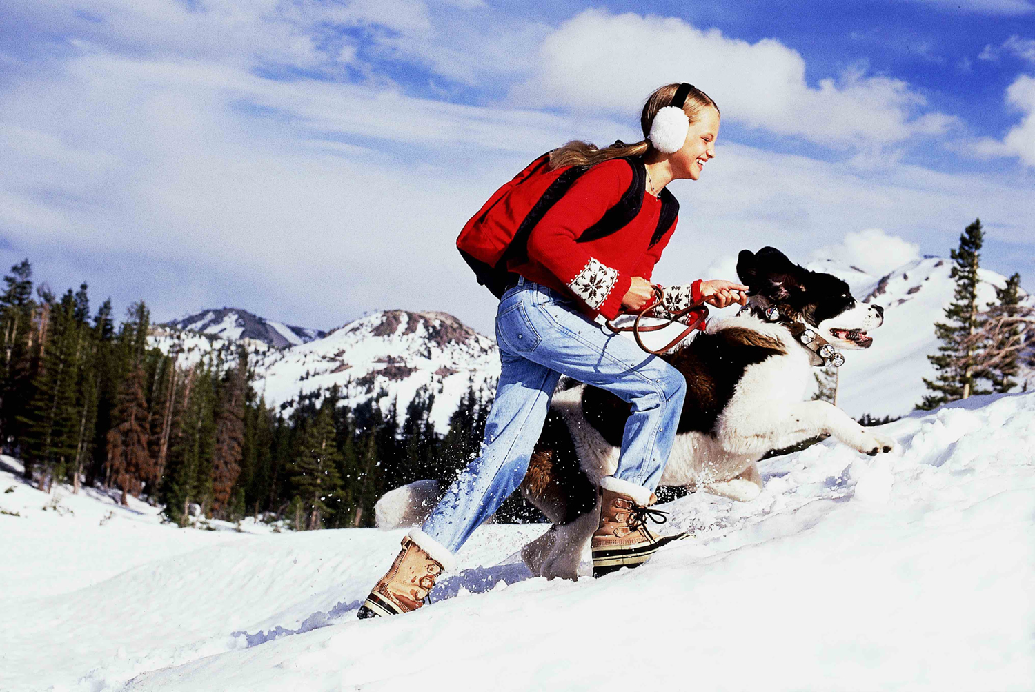 Young girl in the snow with dog